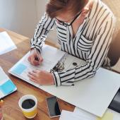 Woman writing in binder