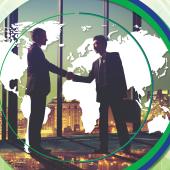 Two men, one Asian, in suits, shaking hands