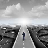  A man in a suit walking on a highway that has many directions. 