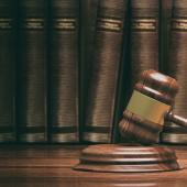 gavel with books, assuming legal books, in background, on shelf-photo