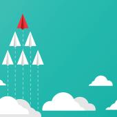 Six planes soaring through the clouds with one red leader at the front. 