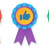 three award ribbons, one red with a heart, one blue and purple with a thumbs up, one green with a thumbs down