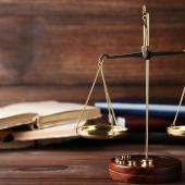 Legal scales next to legal books on a table. 