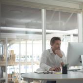 Businessman focuses intently on computer