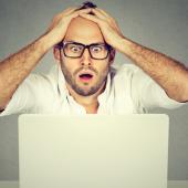 stressed man at laptop