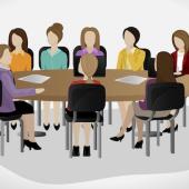 a group of business women at a conference table