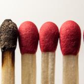 a row of matches. one is burnt out