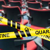 caution tape that reads QUARANTINE marking off rows of chairs