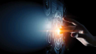 a finger touching a futuristic visual display