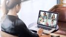 Businesswoman sitting in front of a laptop for a virtual meeting.