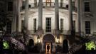 White House lit at night and man walking into the southside entryway